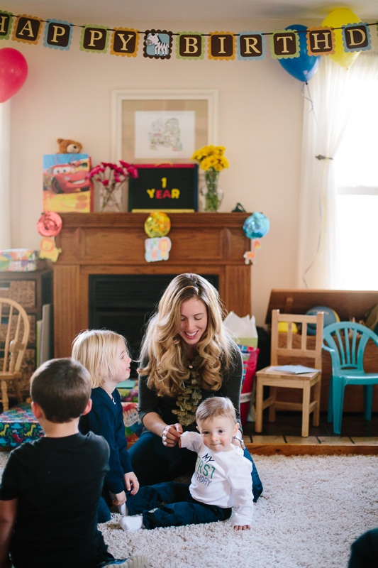mom sitting with baby boy and cousins