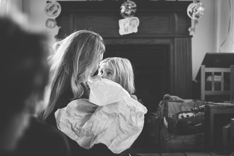 mom holding little boy with long hair