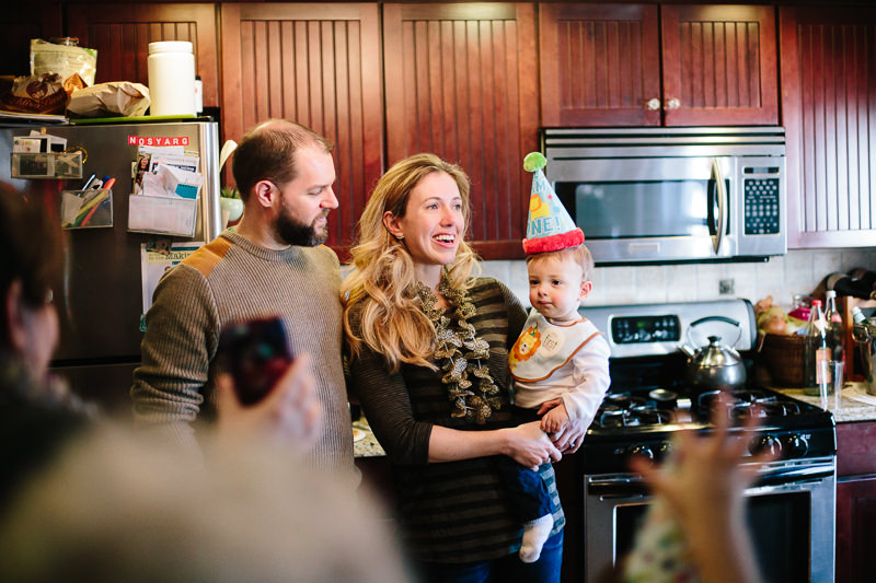 mom holding birthday boy with dad
