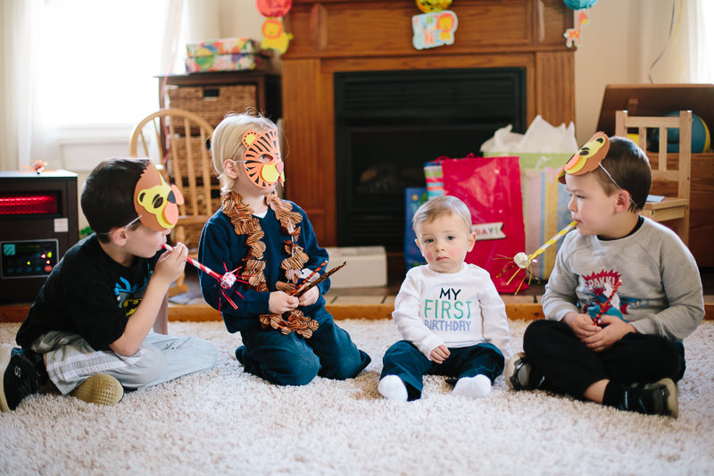 baby sitting with cousins in animal mask