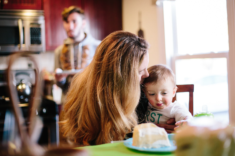 mom holding birthday boy at the table