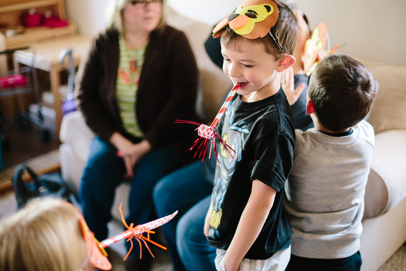 young child wearing mask and birthday toy