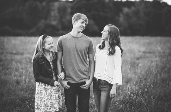 Black and white siblings laughing together