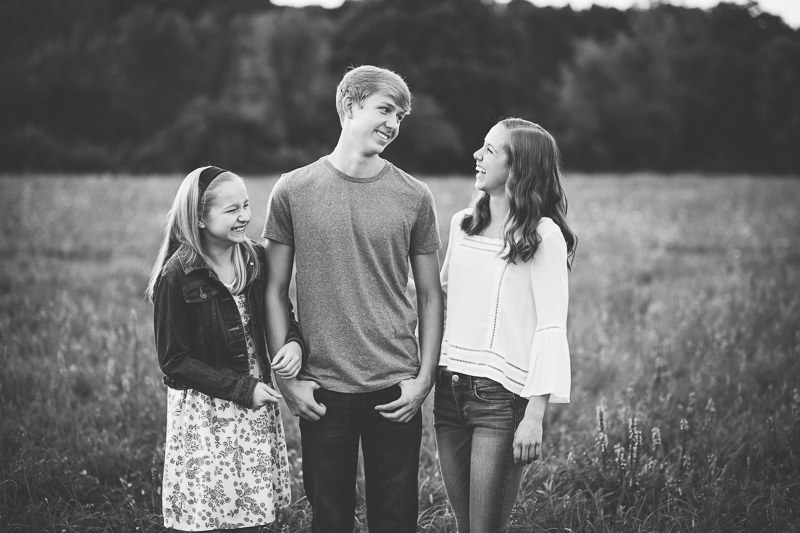 Black and white siblings laughing together