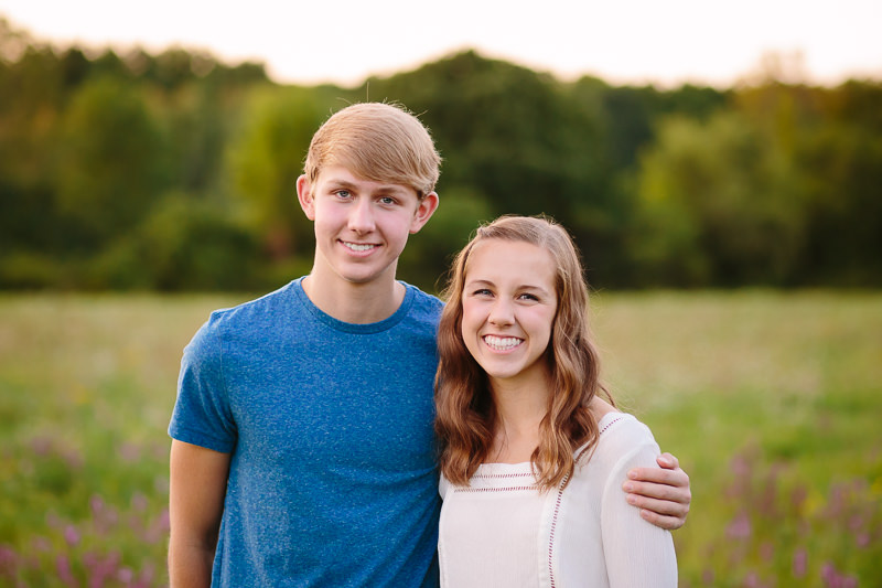 taller brother hugging older sister