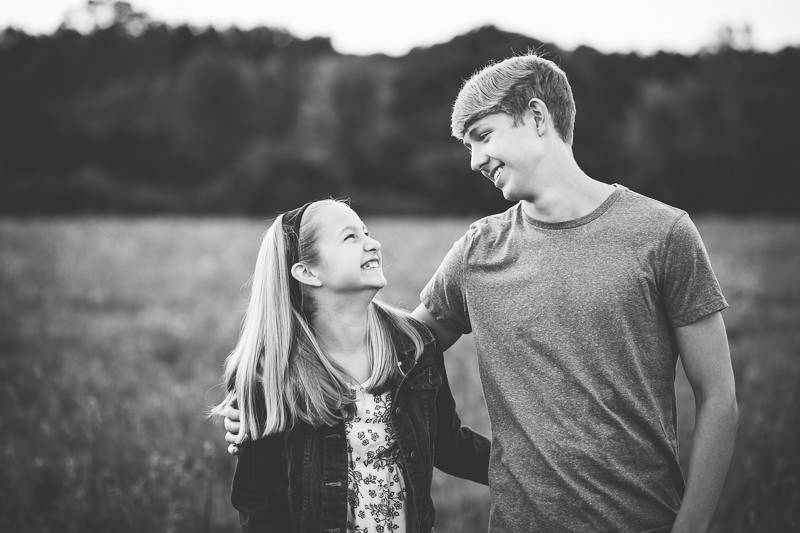 little sister laughing at older brother