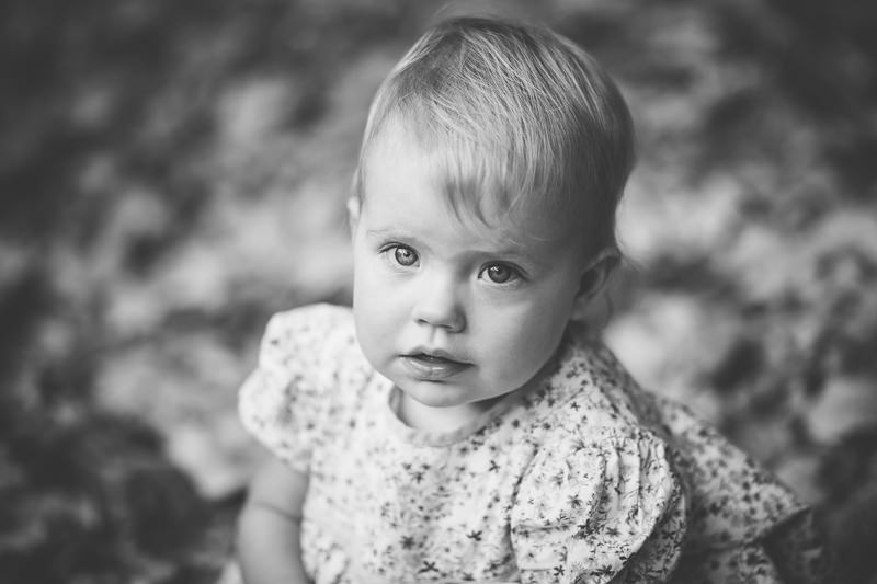 black and white picture of baby in flower dress