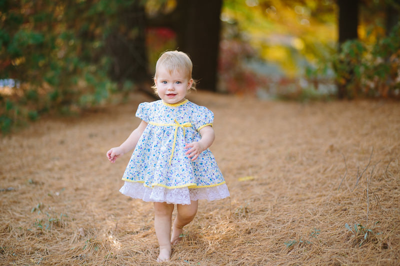 toddler girl walking outside in flower dress