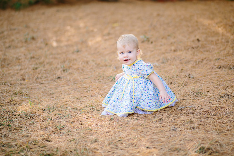 baby girl sitting outside in dress