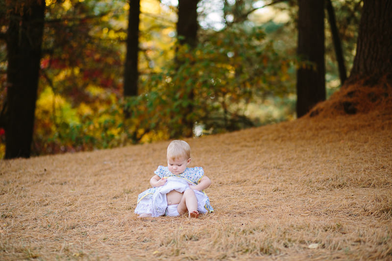 baby girl lifting up dress showing belly button
