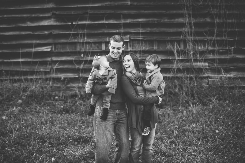 young family smiling at their kids