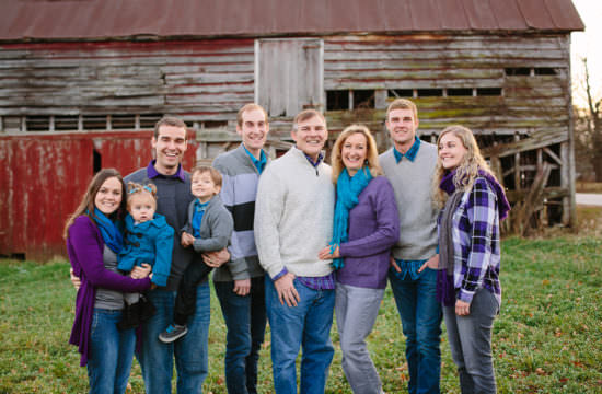 extended family wearing purple teal and grey