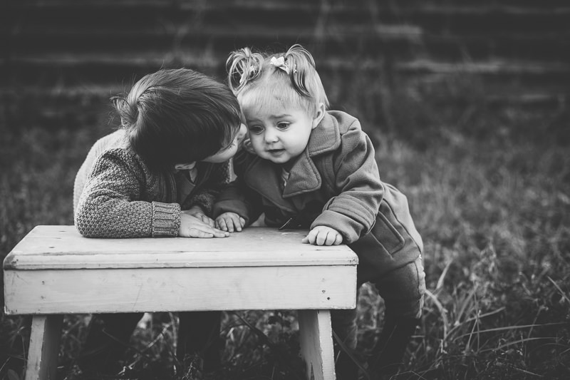 big brother kissing baby sister