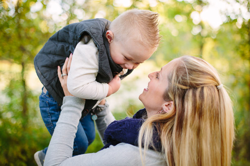 mom holding baby boy above her head