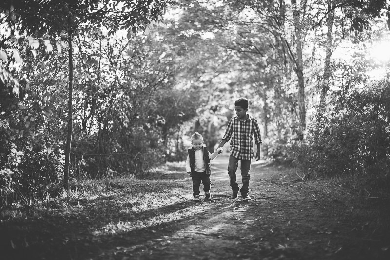 black and white picture brothers holding hands while walking