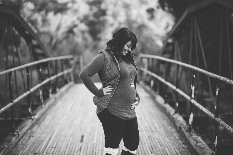 black and white maternity picture on a bridge