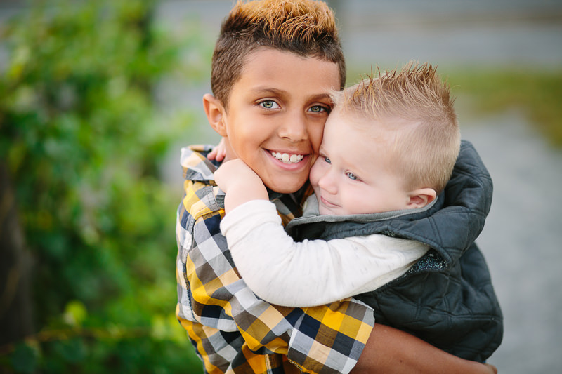 older brother hugging baby brother
