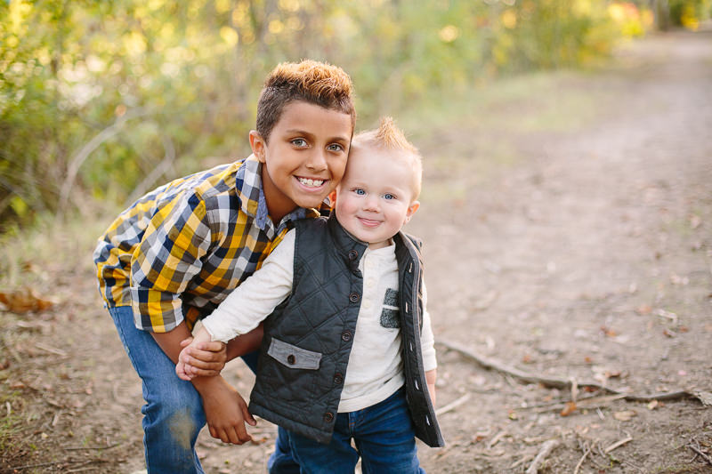older brother standing close to baby brother