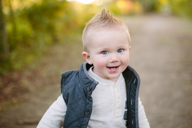 toddler boy with white shirt blue vest and faux hawk