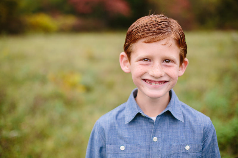 young boy with red hair and blue shirt