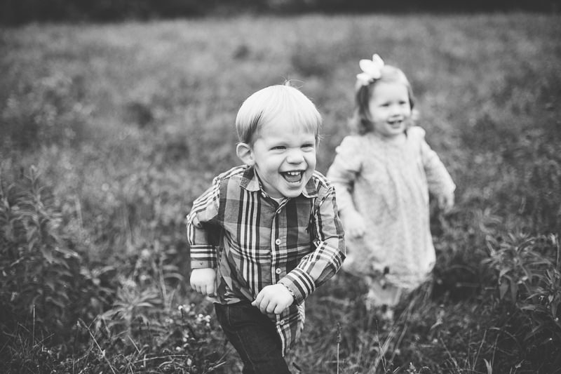 twin boy and girl running to their parents