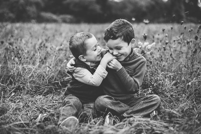 brothers sitting outside hugging