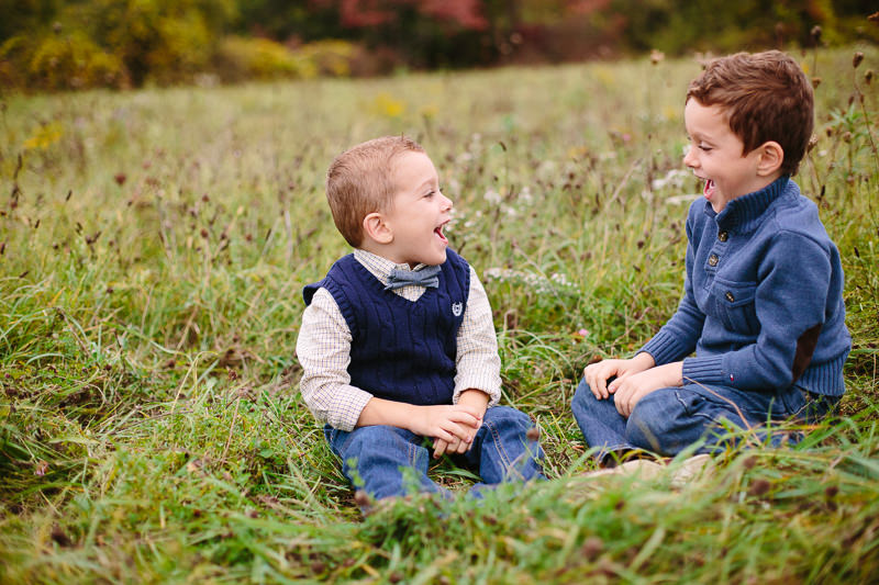 two little boys laughing at each other