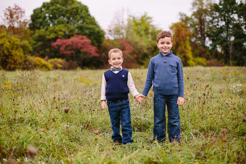 brothers holding hands in a field