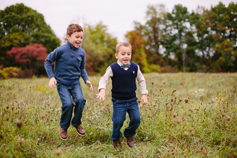 brothers jumping in a field