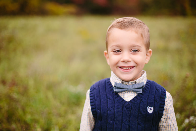 little boy with blue vest and bow tie 