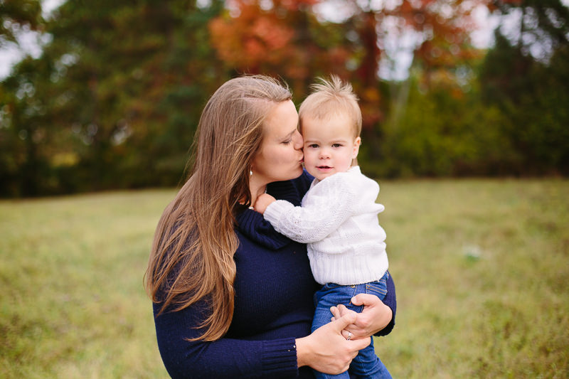 mom kissing toddler girl on the cheek