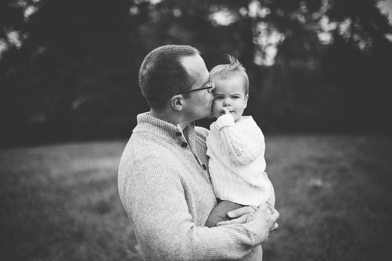 dad kissing baby girl on cheek