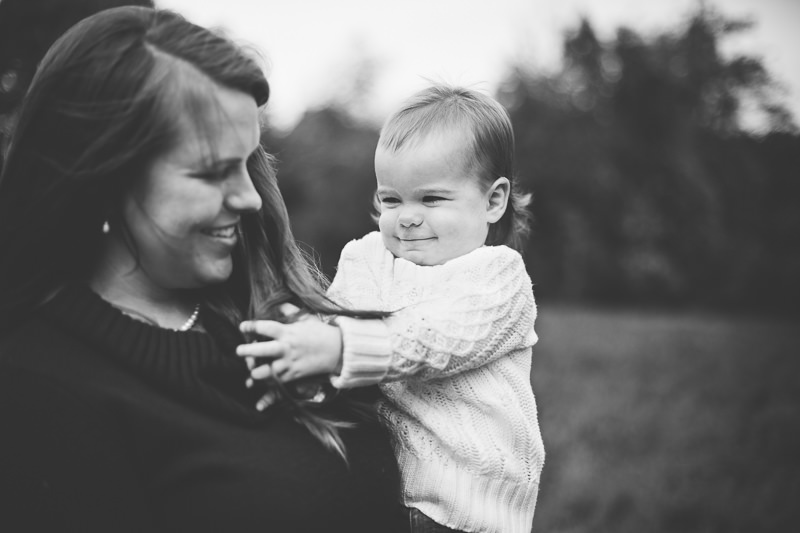 baby girl playing with moms hair