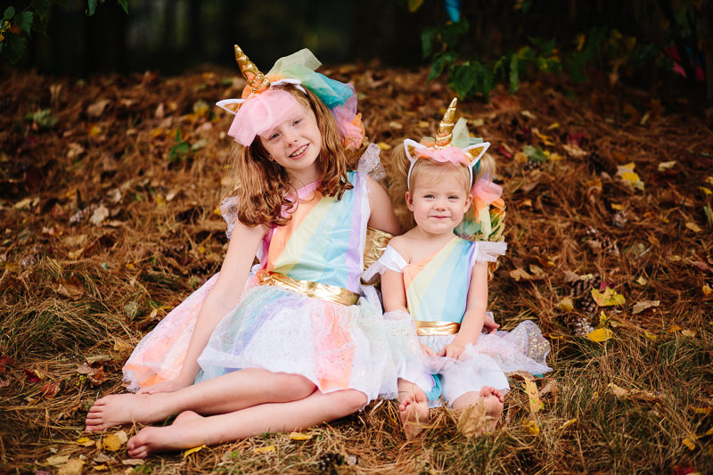 Sisters wearing matching unicorn costumes