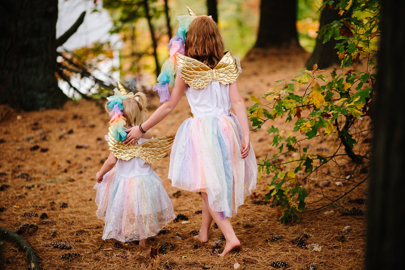 Sisters walking through forest in matching costume