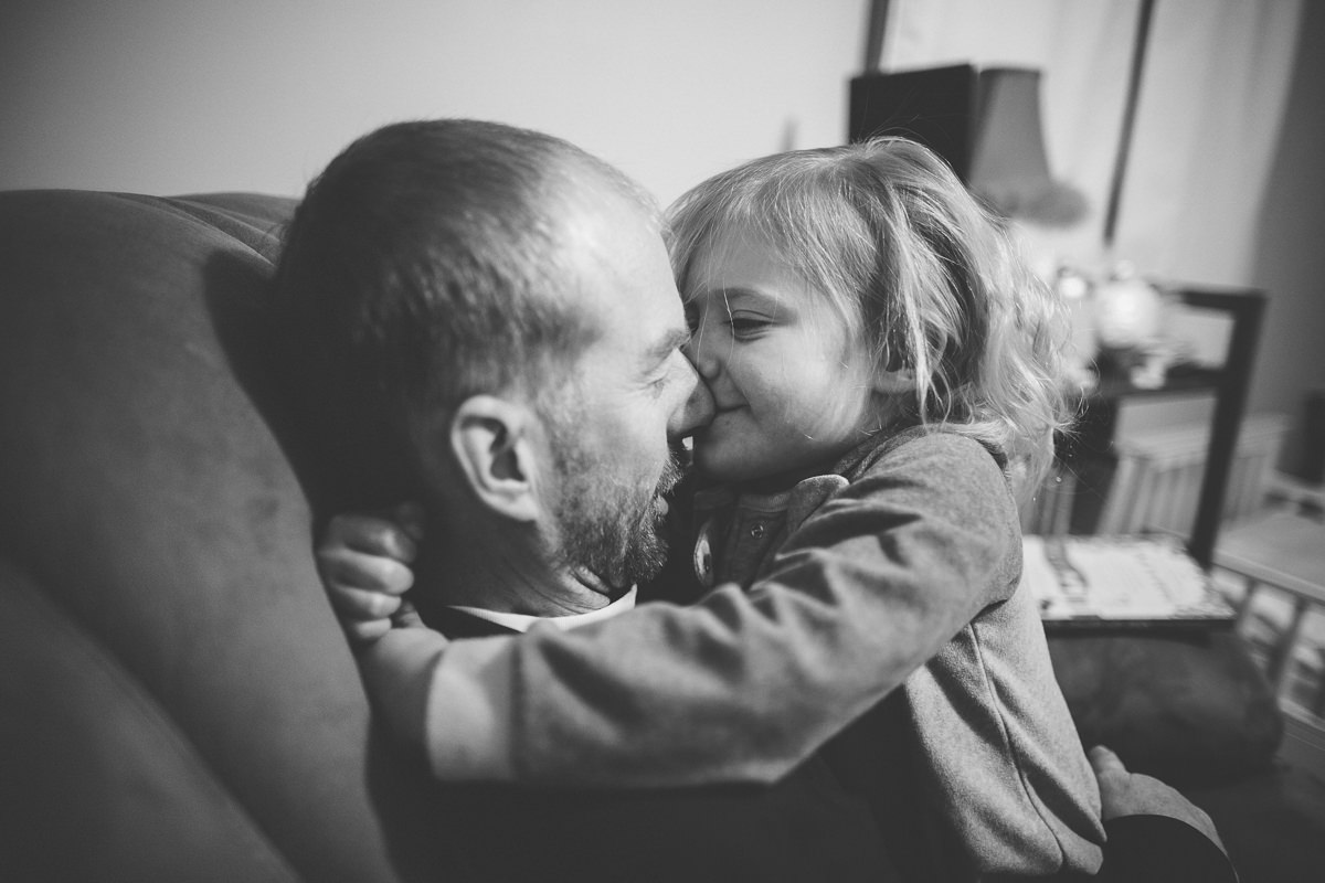 toddler kissing dad on the nose