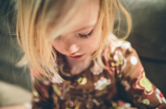 little girl looking down with long eyelashes