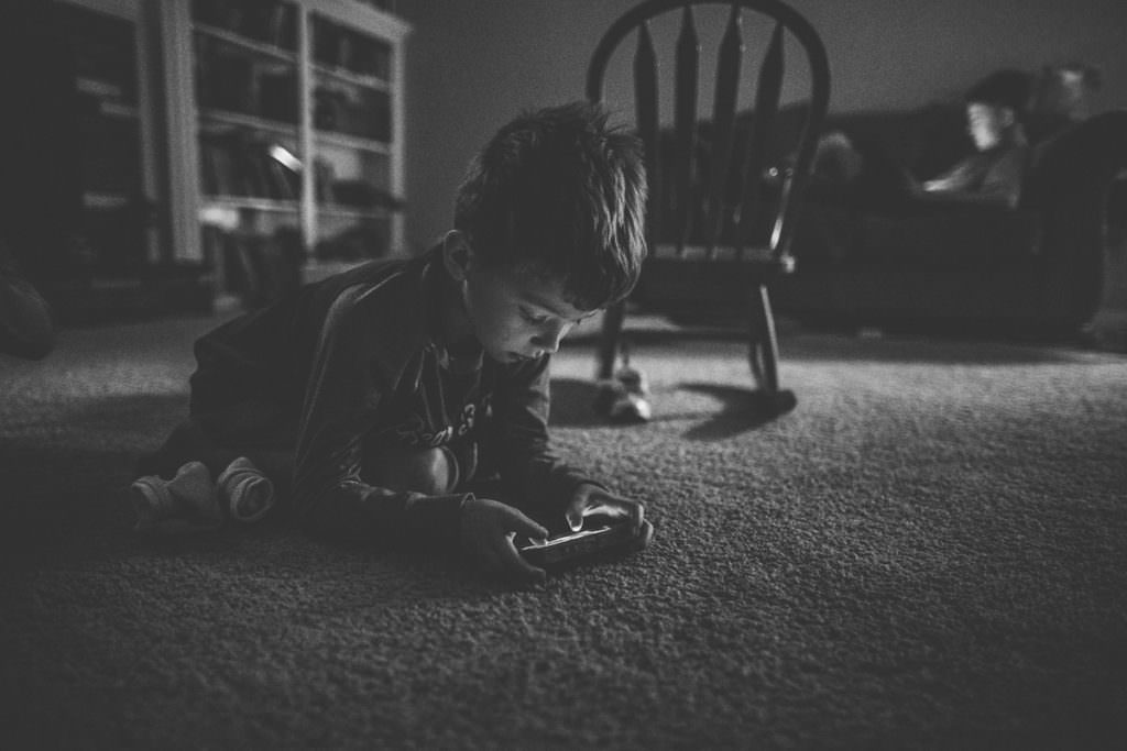 boy playing on a phone in the dark