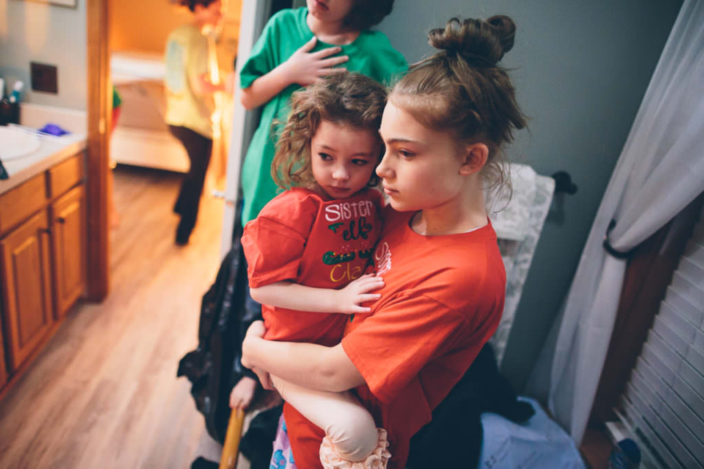 big sister holding little sister