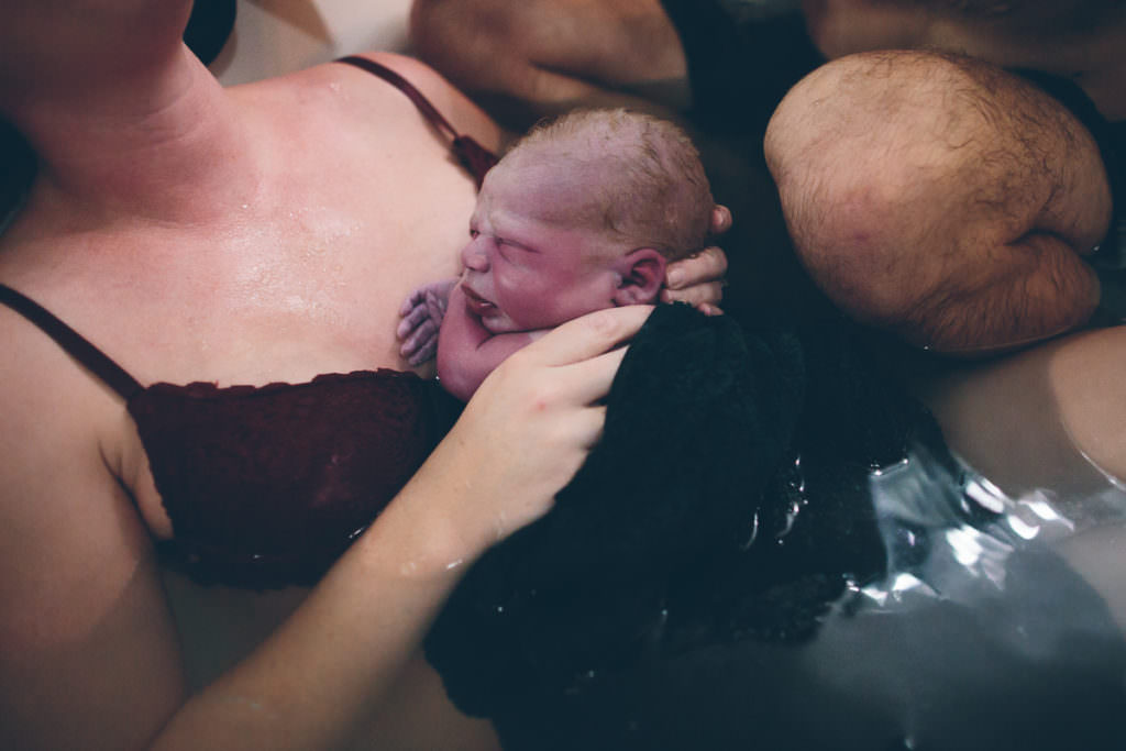 water birth newborn baby on mom chest