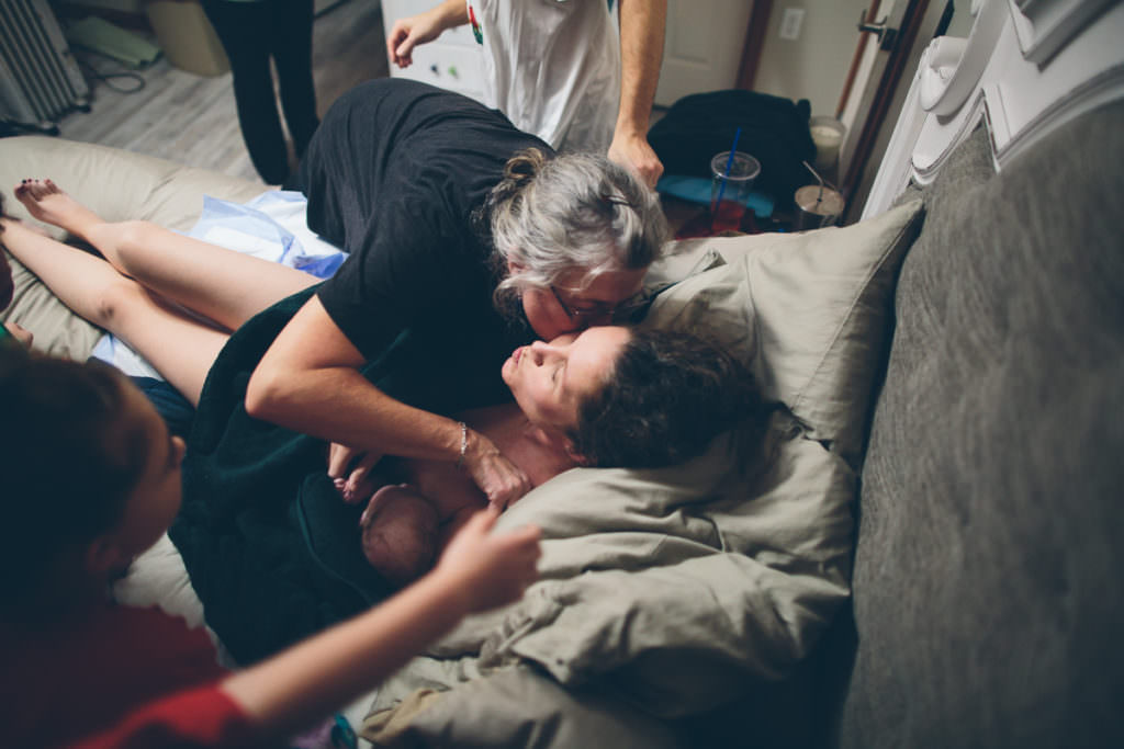 midwife kissing mom goodbye homebirth