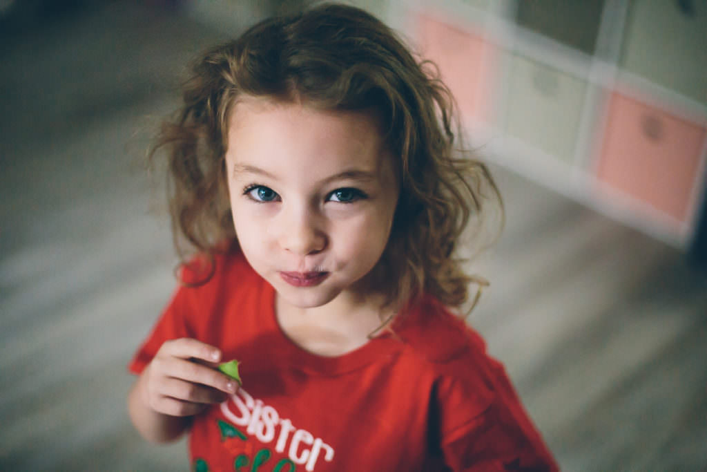 blue eyed girl eating apple