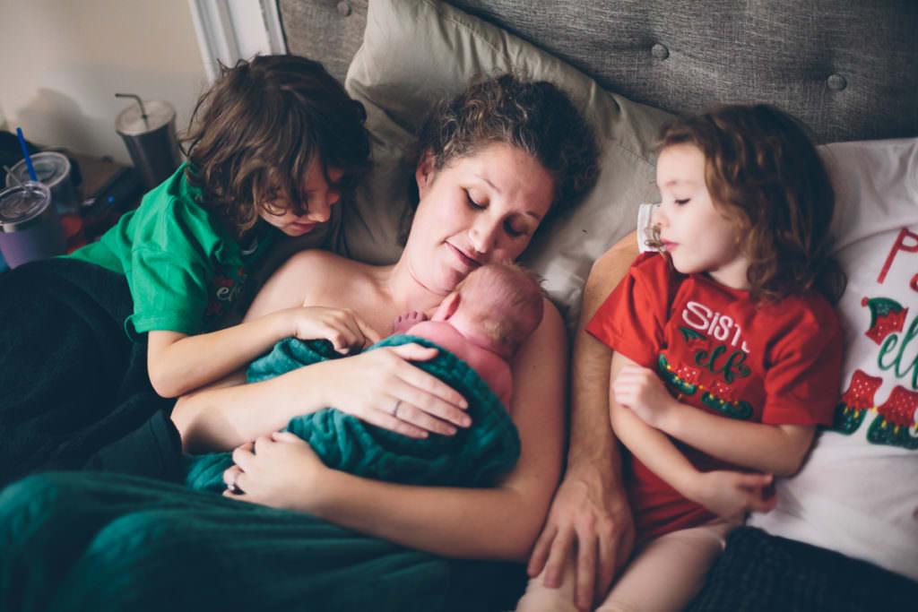 checking out baby brother after home birth