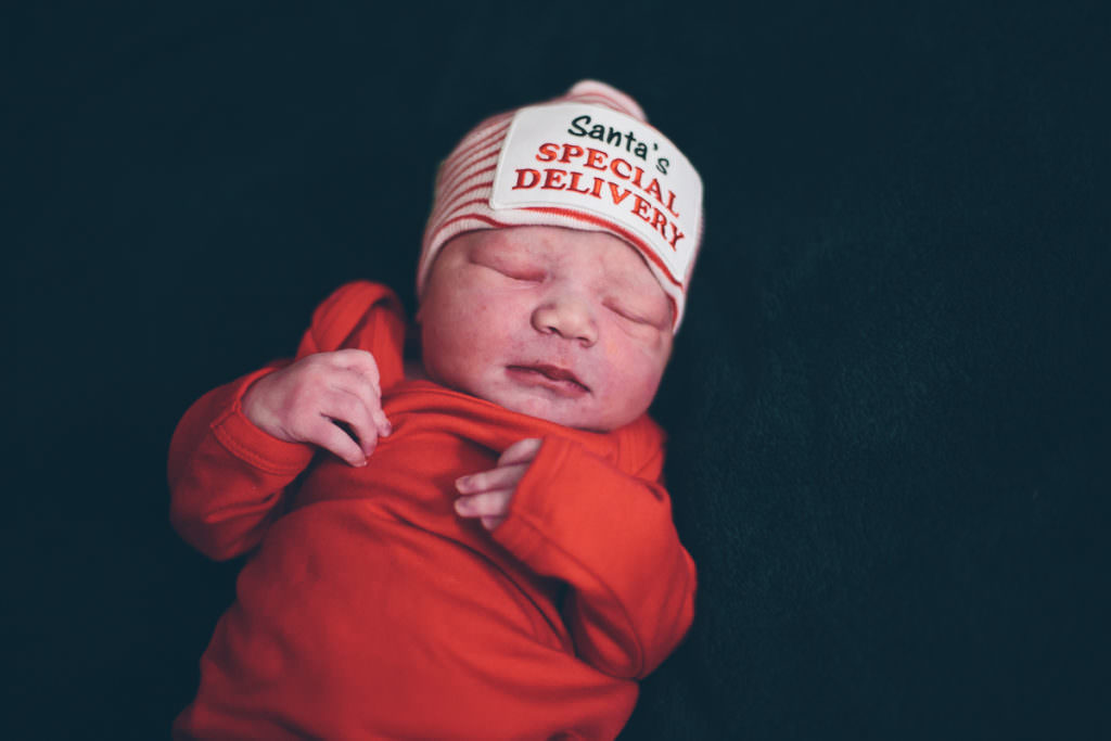 newborn dressed in red after homebirth