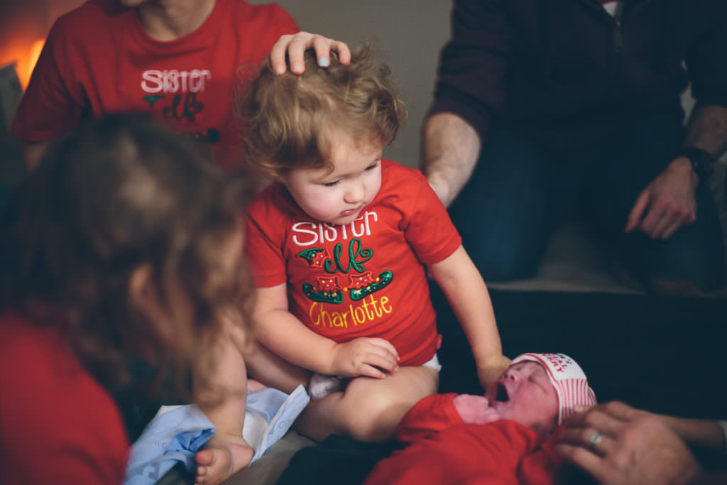 baby sister checking out her new brother