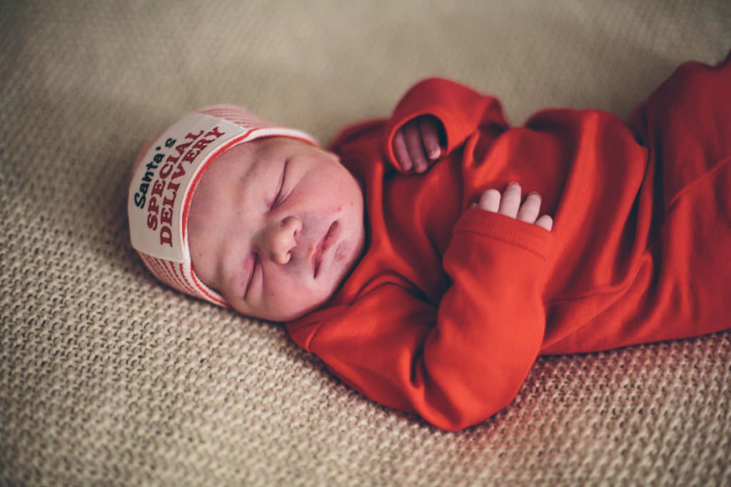newborn baby boy in red shirt
