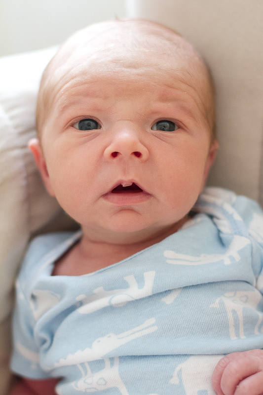 newborn baby boy in blue onsie