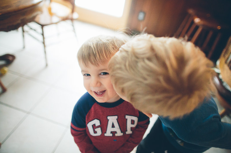 brother kissing little brother on cheek