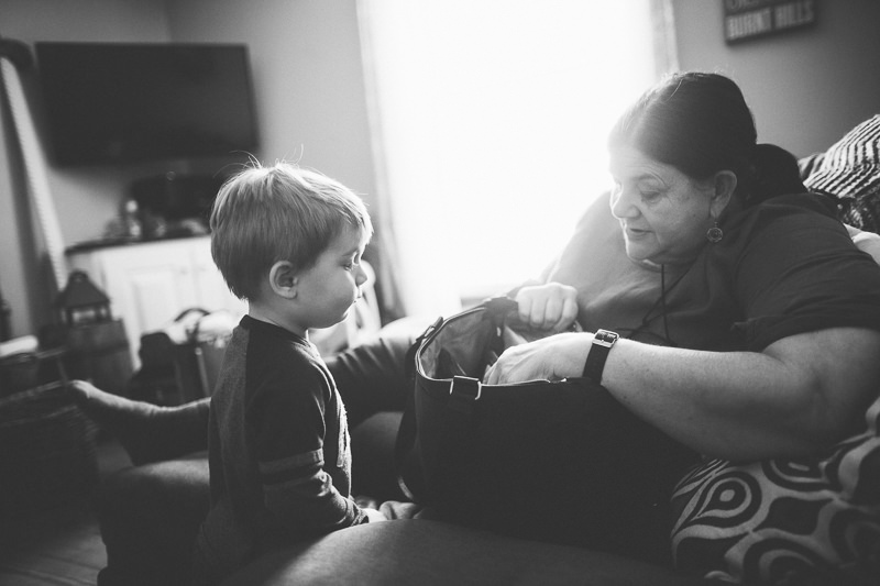 little boy looking in midwife bag