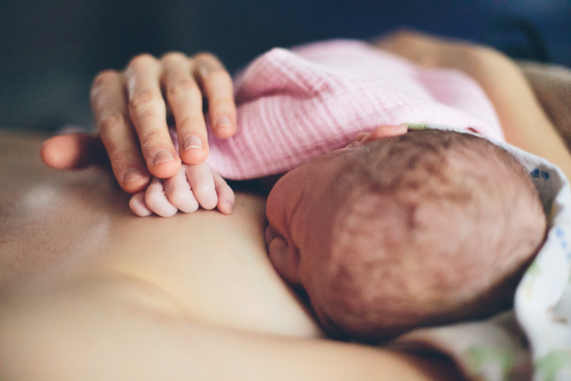 breastfeeding newborn mom and baby hand